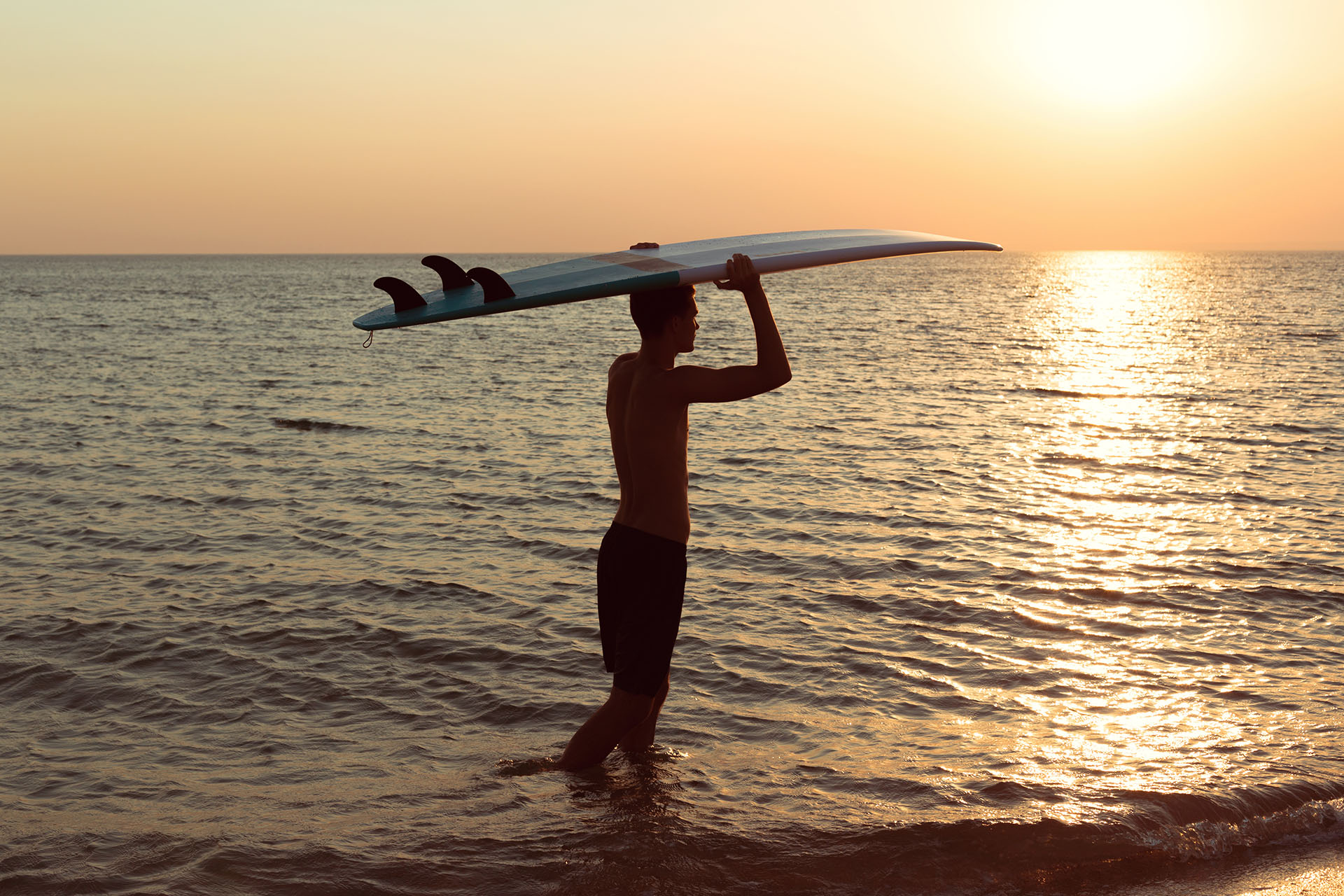 A surfer at sunset.